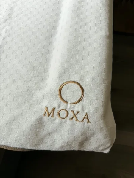 MOXA branded pillow in a treatment room at 13 Clarence Square Toronto