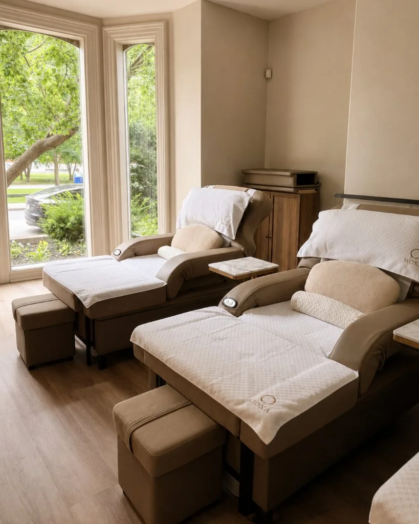 Two reclining treatment chairs in a bright room at Moxa Wellness Toronto